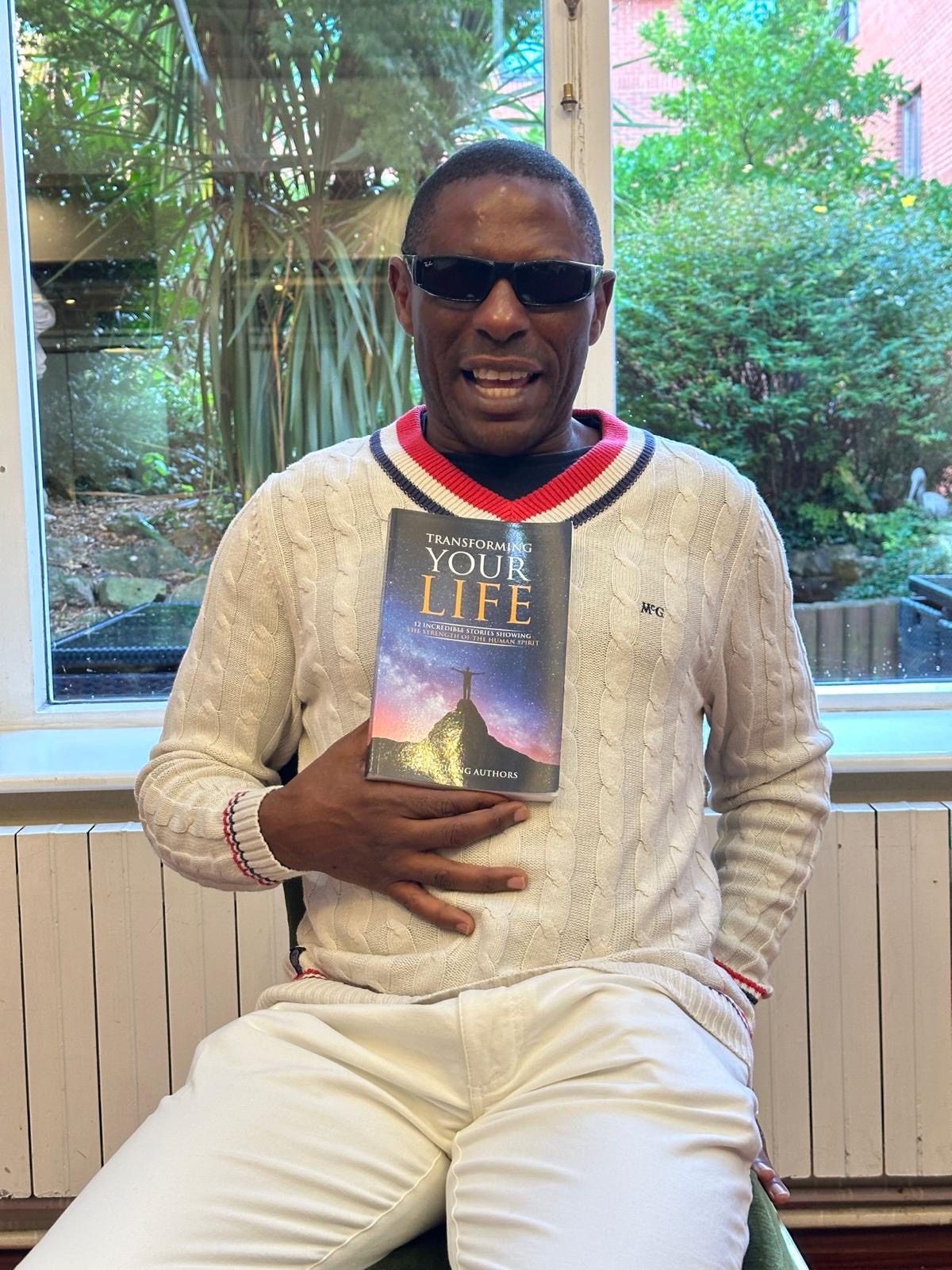 Darren Harris holding a book